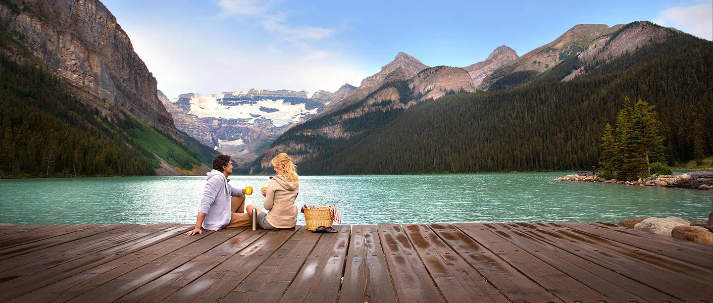 A couple is enjoying the beautiful scene of Lake-Louise